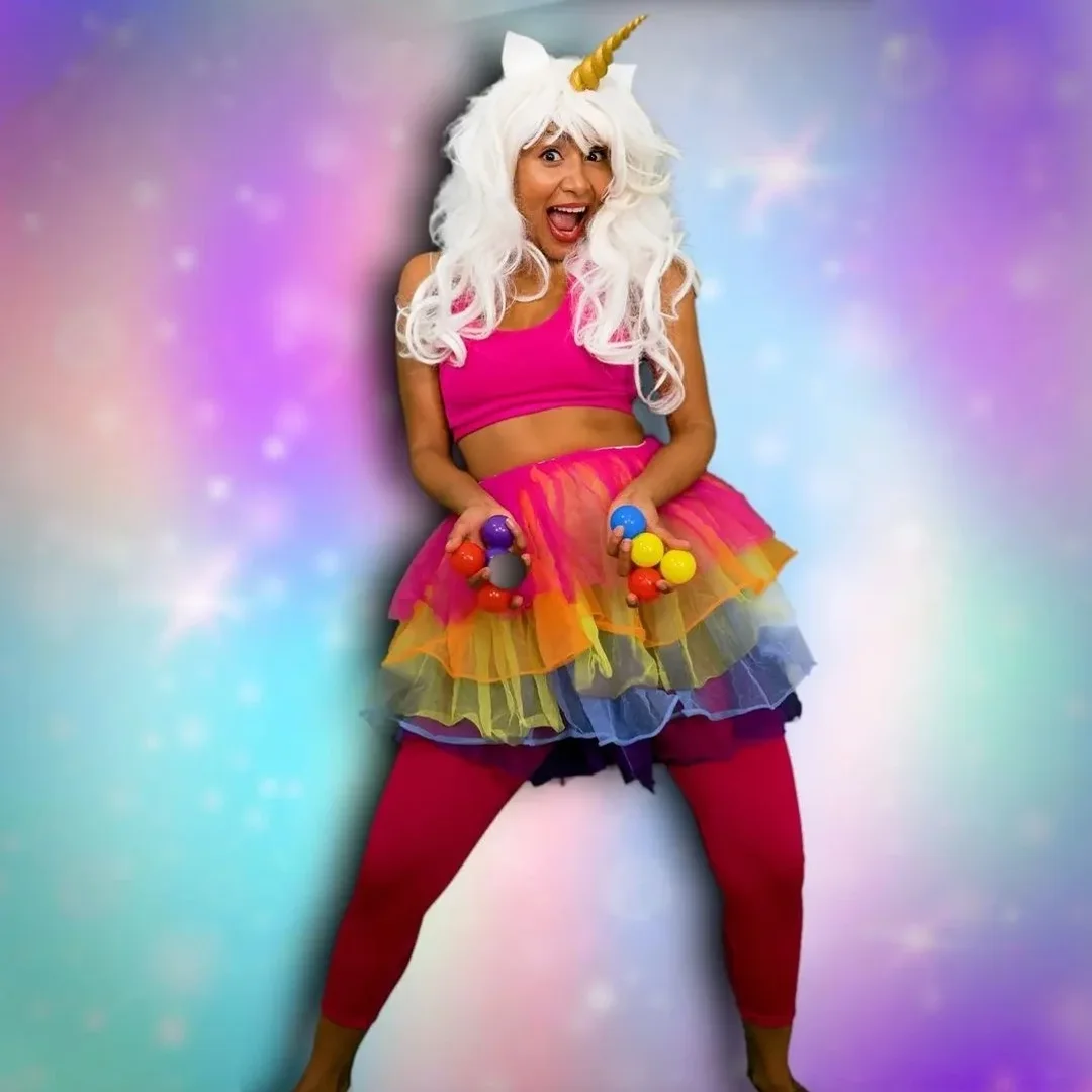 Anusha, founder and party entertainer, in a colourful rainbow unicorn costume